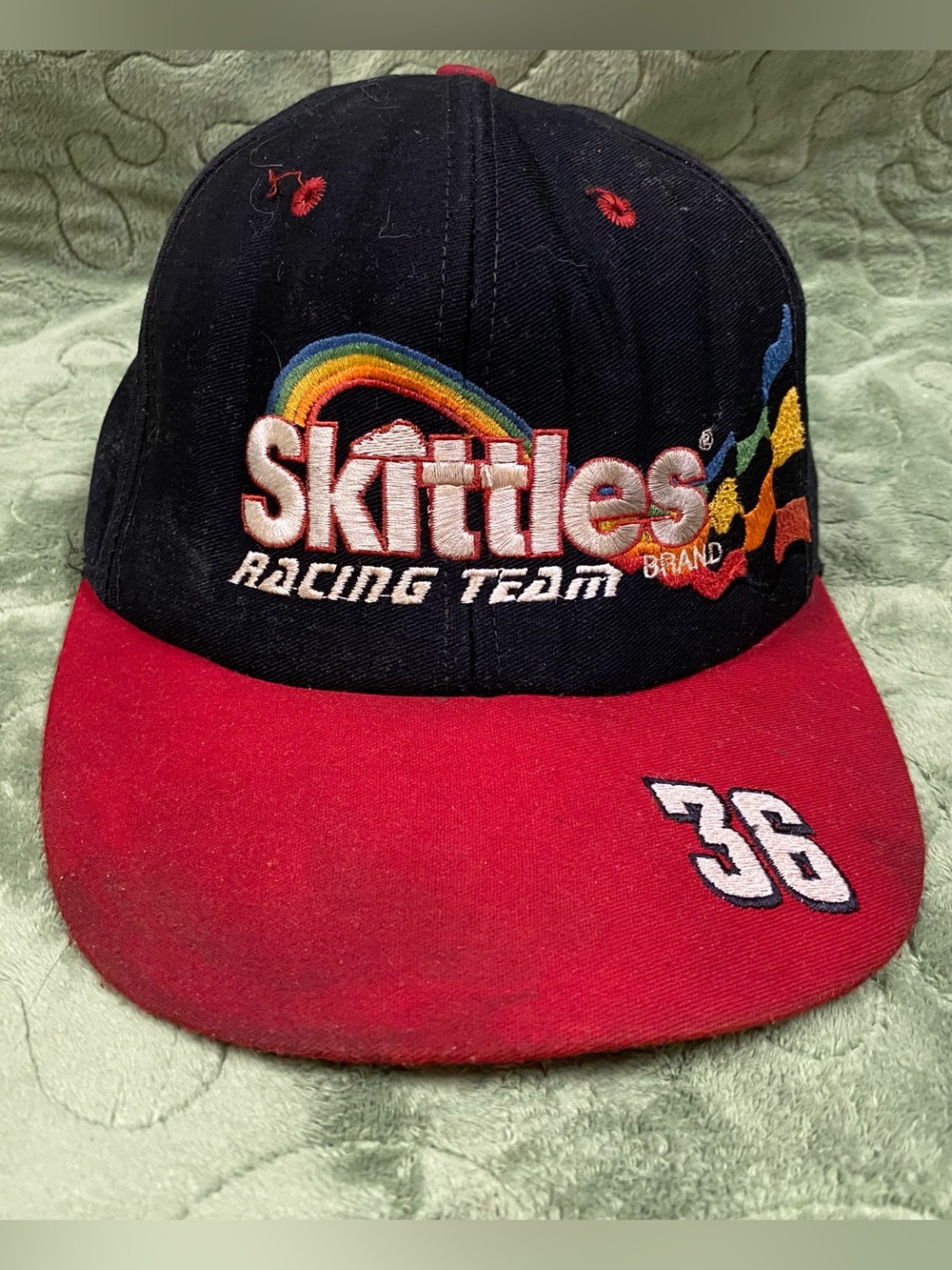 Skittles Racing Team SnapBack trucker hat, Black and Red, stained